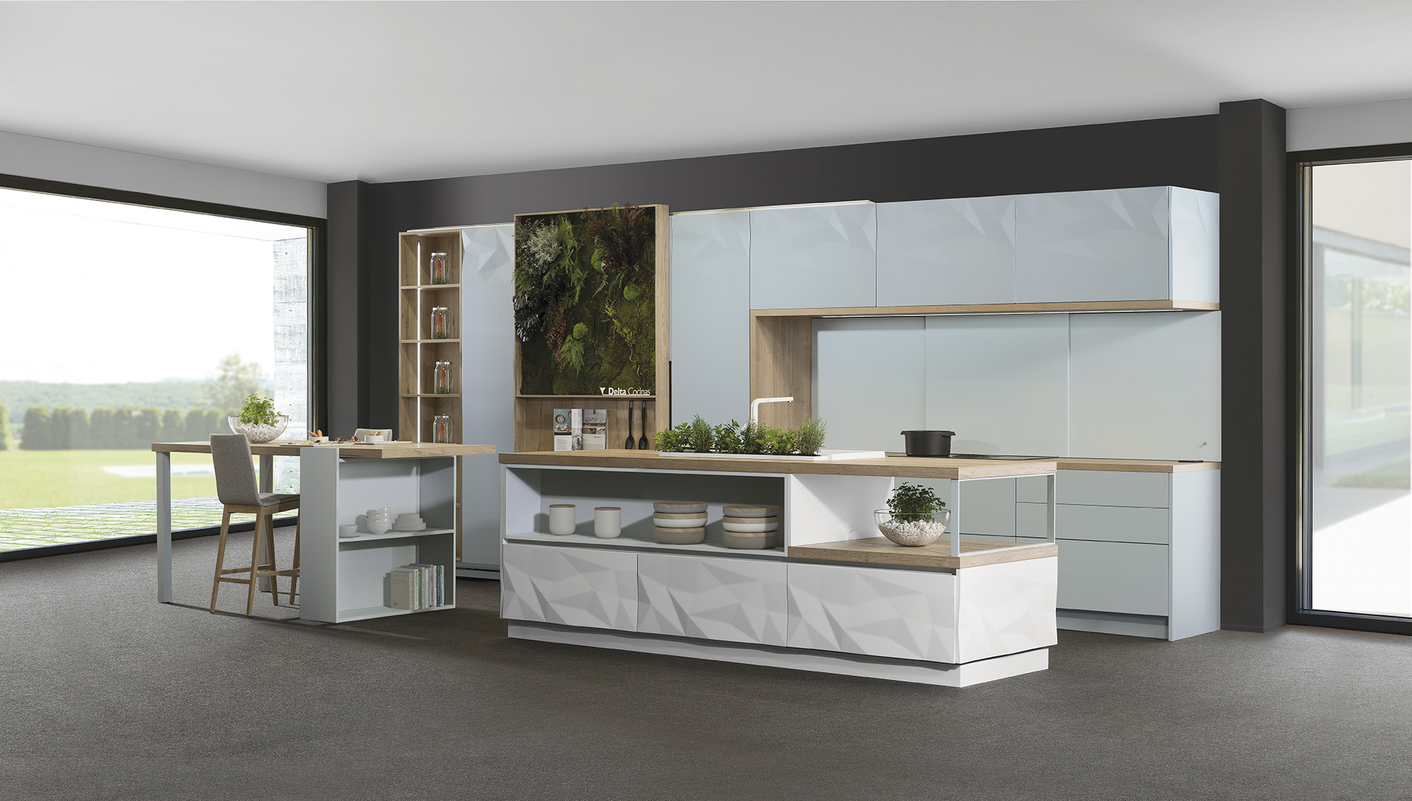 Cocina de diseño contemporáneo que destaca por su integración con el entorno exterior gracias a los grandes ventanales. La isla central, con texturas geométricas y estantes abiertos, aporta dinamismo y funcionalidad, mientras que el jardín vertical introduce un toque natural al ambiente moderno.