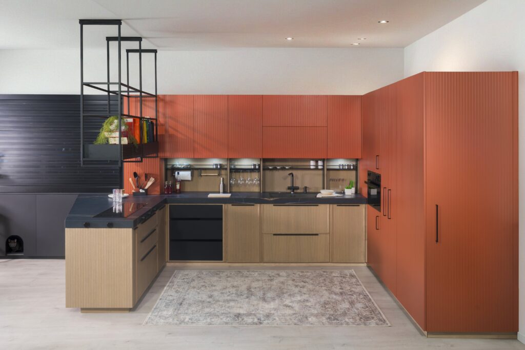 Cocina moderna con armarios naranjas que aportan un toque vibrante. Encimeras elegantes y electrodomésticos funcionales completan este espacio acogedor y lleno de estilo.